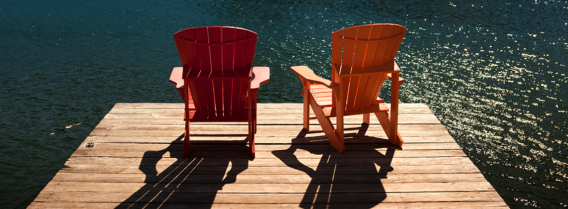 Two chairs on a dock by the lake
