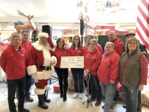 Santa and Christmas Cheer Volunteers holding a oversized donation cheque
