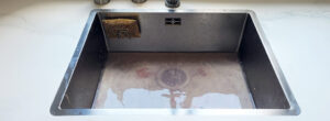 Photo of a clogged kitchen sink.