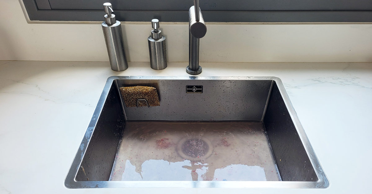 Photo of a clogged kitchen sink.